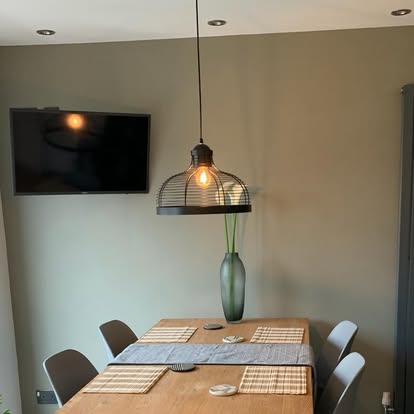 A pendant light hanging over a dining table