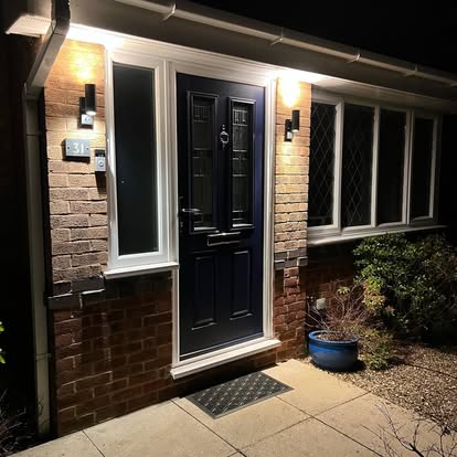 A front door with a light beside it