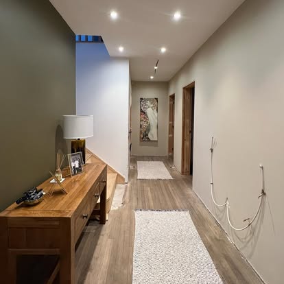 A hallway with downlights set into the ceiling