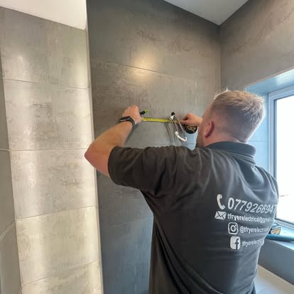 Tom Fryer marking out a wall with a tape measure